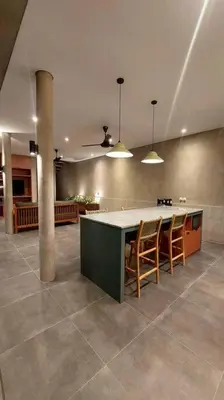 a kitchen with a table and chairs in a room at Villa Akhila 2 - 2 BR modern tropical villa at the heart of Seminyak in Seminyak
