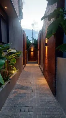 a walkway with a light at the end of a building at Villa Akhila 2 - 2 BR modern tropical villa at the heart of Seminyak in Seminyak