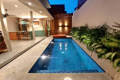 a swimming pool in the middle of a house at Akhila 3 - 2 BR Modern tropical villa at the heart of Seminyak in Seminyak