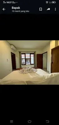 a picture of a bedroom with a large bed at Apartment Wayan in Canggu