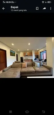 a bedroom with a large bed and a couch at Apartment Wayan in Canggu