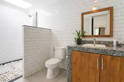 a bathroom with a toilet and a sink and a mirror at Modern villa near Atlas beach club & beach in Canggu