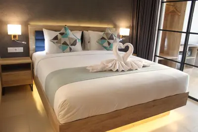 a bedroom with a bed with two swans on it at Anagata Hotels and Resorts Tanjung Benoa in Nusa Dua