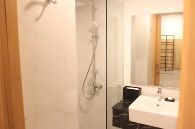 a bathroom with a shower and a sink at Anagata Hotels and Resorts Tanjung Benoa in Nusa Dua