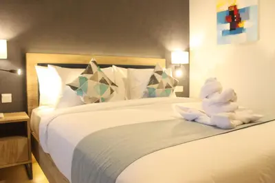 a white teddy bear sitting on a bed at Anagata Hotels and Resorts Tanjung Benoa in Nusa Dua