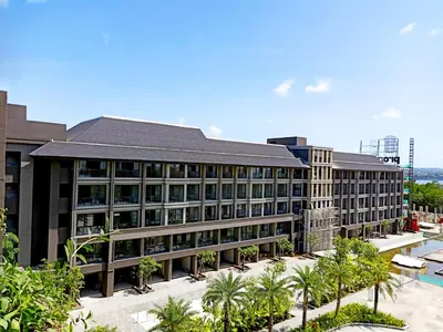 a large building with a lot of windows and trees at Anagata Hotels and Resorts Tanjung Benoa in Nusa Dua
