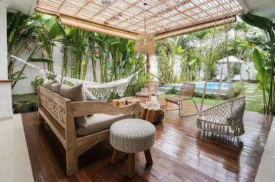 a living room with a hammock and a pool at Incredible villa near Atlas beach club Berawa in Canggu