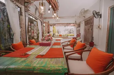 a dining room with a long table and chairs at Bohemian Kasya Villa Bali in Seminyak