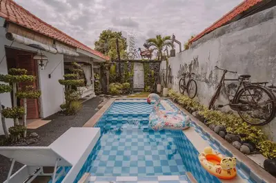 a swimming pool in a house with an inflatable at Bohemian Kasya Villa Bali in Seminyak