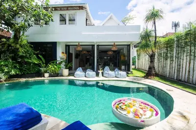 a pool with chairs and a toy in the water at Monroe 3BR Luxury Villa Seminyak BREAKFAST INCL Netflix Private Pool 900m to Beach in Seminyak