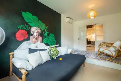 a bedroom with a bed with a painting on the wall at Monroe 3BR Luxury Villa Seminyak BREAKFAST INCL Netflix Private Pool 900m to Beach in Seminyak