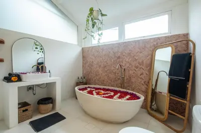 a bathroom with a large tub and a mirror at Monroe 3BR Luxury Villa Seminyak BREAKFAST INCL Netflix Private Pool 900m to Beach in Seminyak