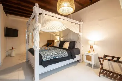 a bedroom with a white canopy bed in a room at Monroe 3BR Luxury Villa Seminyak BREAKFAST INCL Netflix Private Pool 900m to Beach in Seminyak