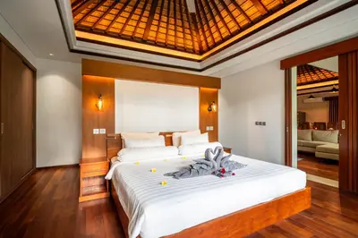 a bedroom with a large white bed in a room at Bali - Jimbaran Beach Villa Private Pool in Jimbaran