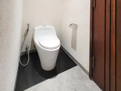 a bathroom with a white toilet in a room at Bali - Jimbaran Beach Villa Private Pool in Jimbaran