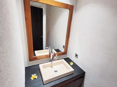 a bathroom with a sink and a mirror at Bali - Jimbaran Beach Villa Private Pool in Jimbaran