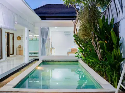 a swimming pool in the middle of a house at Massive 3 bedroom villa in heart of Seminyak in Seminyak