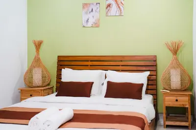 a bedroom with a bed and two vases at Massive 3 bedroom villa in heart of Seminyak in Seminyak