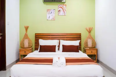 a bedroom with a bed with two vases at Massive 3 bedroom villa in heart of Seminyak in Seminyak