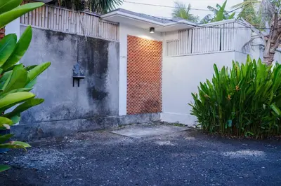 a white house with a wall and a fence at Massive 3 bedroom villa in heart of Seminyak in Seminyak