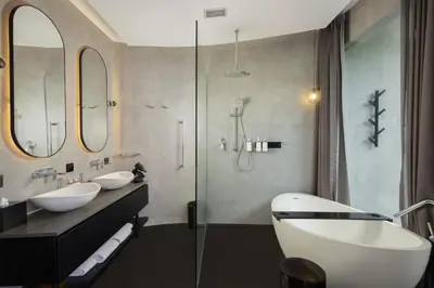 a bathroom with two sinks and a glass shower at Je Ne Sais Quoi Seminyak in Seminyak