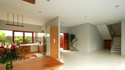 a living room with a table and a kitchen at Modern spacious private pool villa in Central Canggu in Canggu