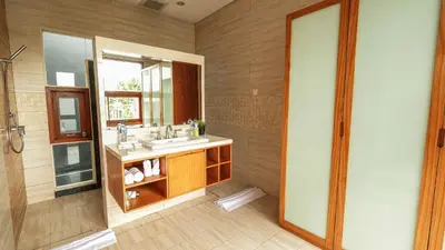 a bathroom with a sink and a mirror at Modern spacious private pool villa in Central Canggu in Canggu