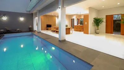 a swimming pool in the middle of a house at Modern spacious private pool villa in Central Canggu in Canggu