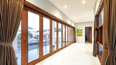 a hallway with large windows in a building at Modern spacious private pool villa in Central Canggu in Canggu
