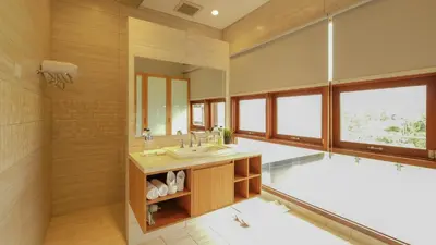 a bathroom with a tub and a sink and a mirror at Modern spacious private pool villa in Central Canggu in Canggu