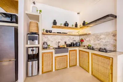 a kitchen with a sink and a stove at Villa Waikiki - Brand New 4BDR with huge Pool in Seminyak