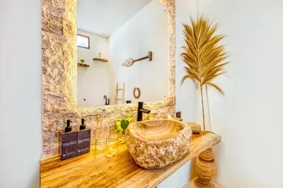 a bathroom with a large wooden bowl sink on a wooden counter at Villa Waikiki - Brand New 4BDR with huge Pool in Seminyak