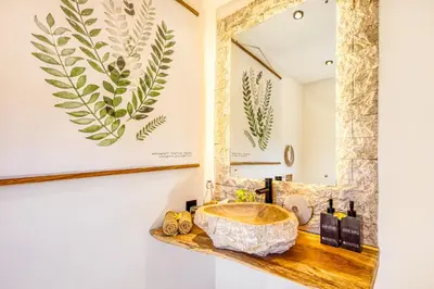 a bathroom with a sink and a mirror at Villa Waikiki - Brand New 4BDR with huge Pool in Seminyak