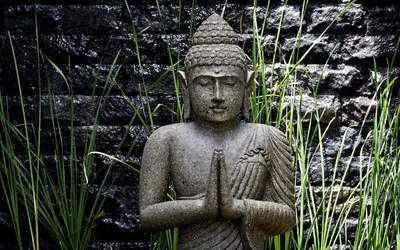 a statue in front of a brick wall at Villa Ziba in Seminyak