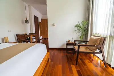 a bedroom with a bed and a table and chairs at Villa Ziba in Seminyak
