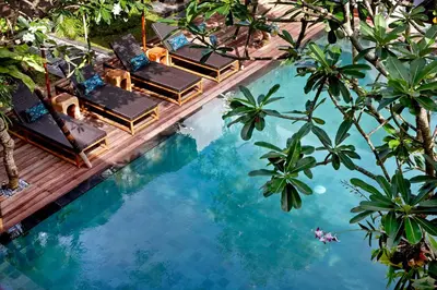 an overhead view of a swimming pool with chaise lounge chairs at Villa Ziba in Seminyak
