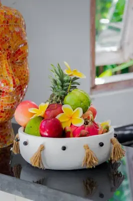 a bowl of fruit sitting on top of a table at Villa Rama Sita - 100m from Eat Street, 3BR in Seminyak