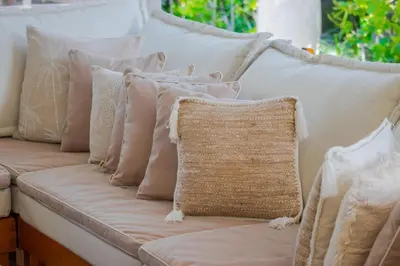 a white couch with pillows and a pillow on it at Villa Rama Sita - 100m from Eat Street, 3BR in Seminyak