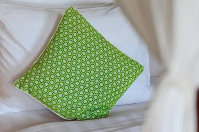 a green pillow sitting on top of a bed at Villa Rama Sita - 100m from Eat Street, 3BR in Seminyak