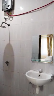 a bathroom with a sink and a mirror at Tambak Sari Villa in Jimbaran