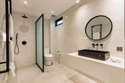 a bathroom with a sink and a mirror at Manresa Villa Bali 4 in Canggu