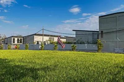 an american flag in the grass in front of a building at Manresa Villa Bali 4 in Canggu