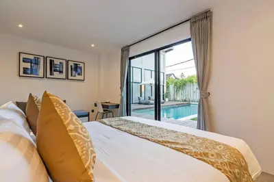 a bedroom with a bed and a large window at Manresa Villa Bali 4 in Canggu