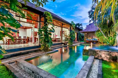 an exterior view of a house with a swimming pool at Villa Taksu Legian in Legian