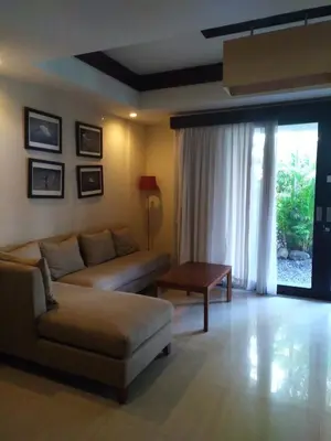 a living room with a couch and a table at LBV Seminyak Apartment in Seminyak