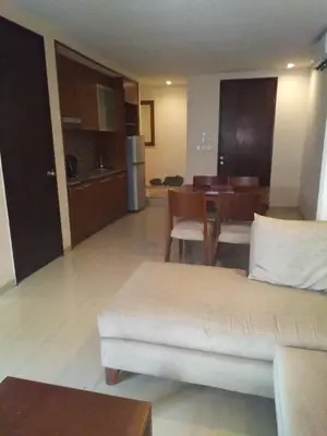 a living room with a couch and a table at LBV Seminyak Apartment in Seminyak