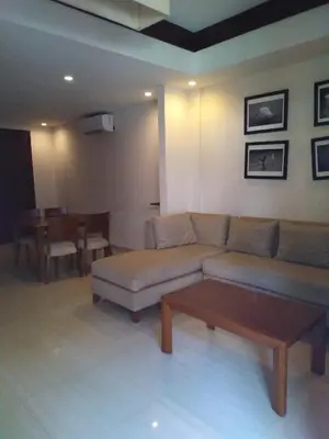 a living room with a couch and a table at LBV Seminyak Apartment in Seminyak