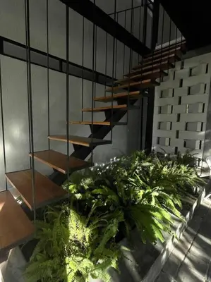 a staircase in a building with some plants at The Drupadi Apartments Studio Gordy in Seminyak