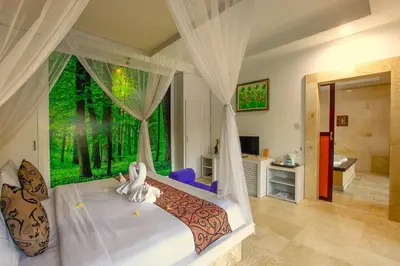 a bedroom with a bed with a large window at Private Pool Villas Kuta Bali in Kuta