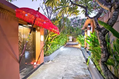 a red umbrella is hanging over a walkway at Private Pool Villas Kuta Bali in Kuta